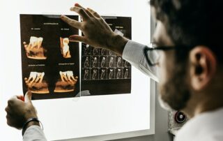Dentist looking at patient X-ray