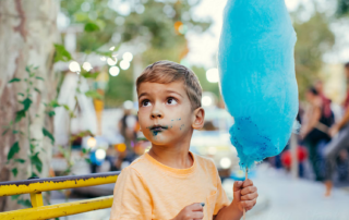 Kid eating candy floss