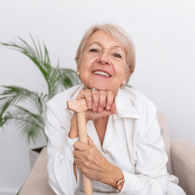 elderly woman with dentures smiling at camera