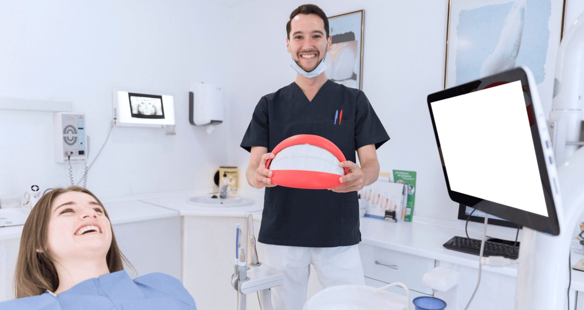 happy dentist holding big teeth model
